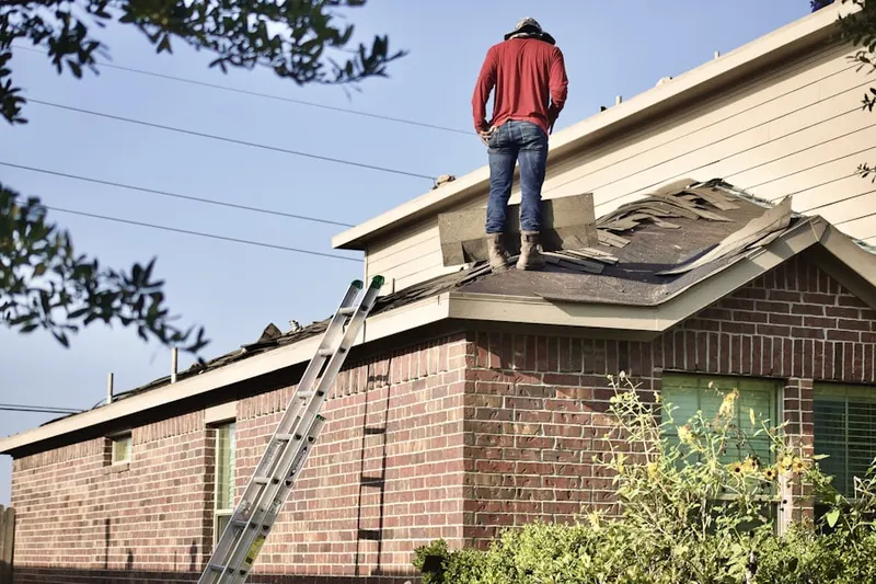 Professional roofer working on a residential roof in Tarheel Courts